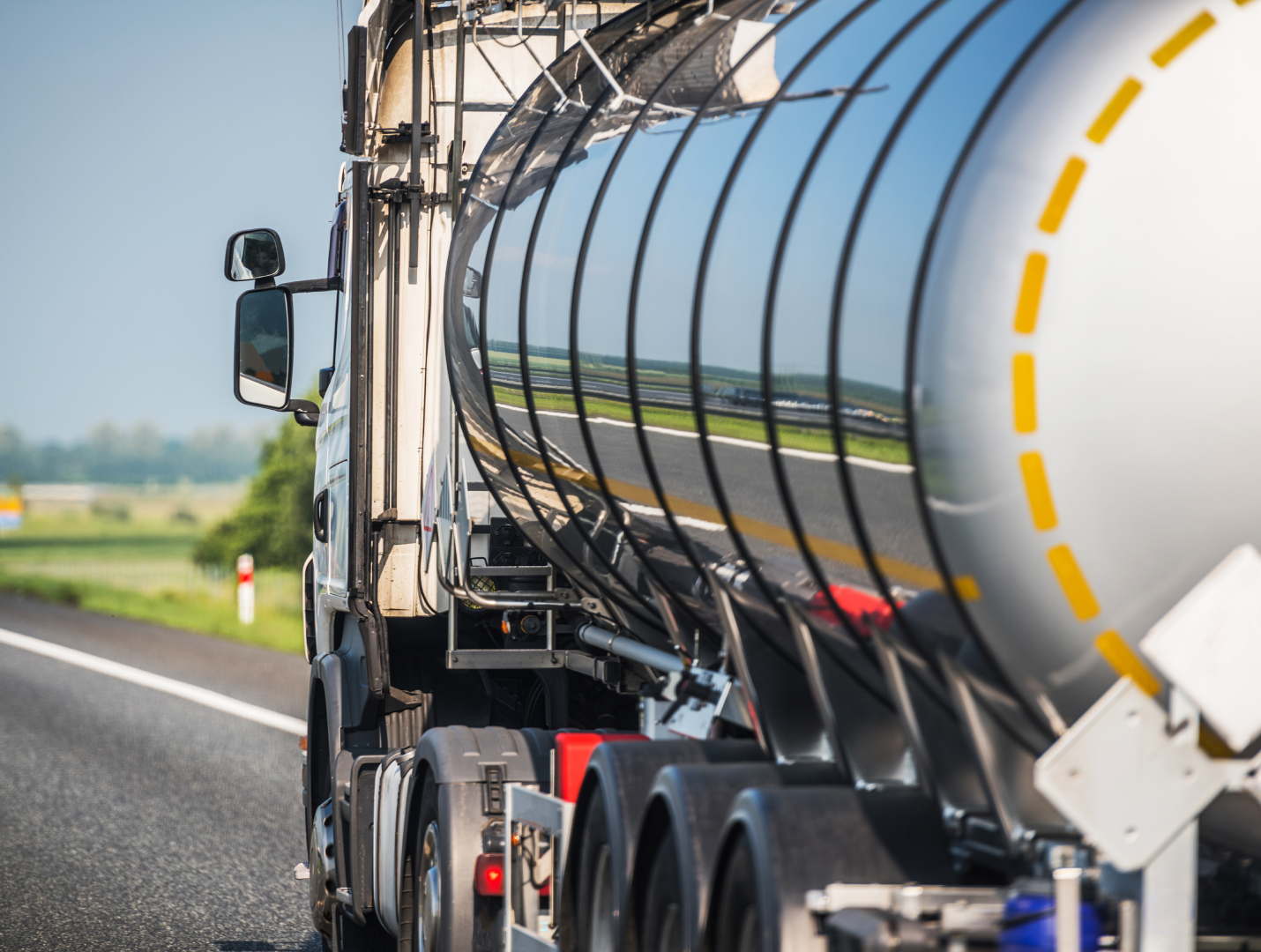Collage of trucks: a tanker truck, a white truck in the sun, the back of a van. Text: 'International standards and requirements.